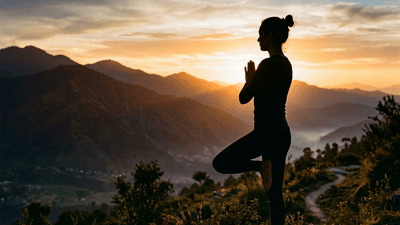 Person doing yoga at sunrise with mountains in the background